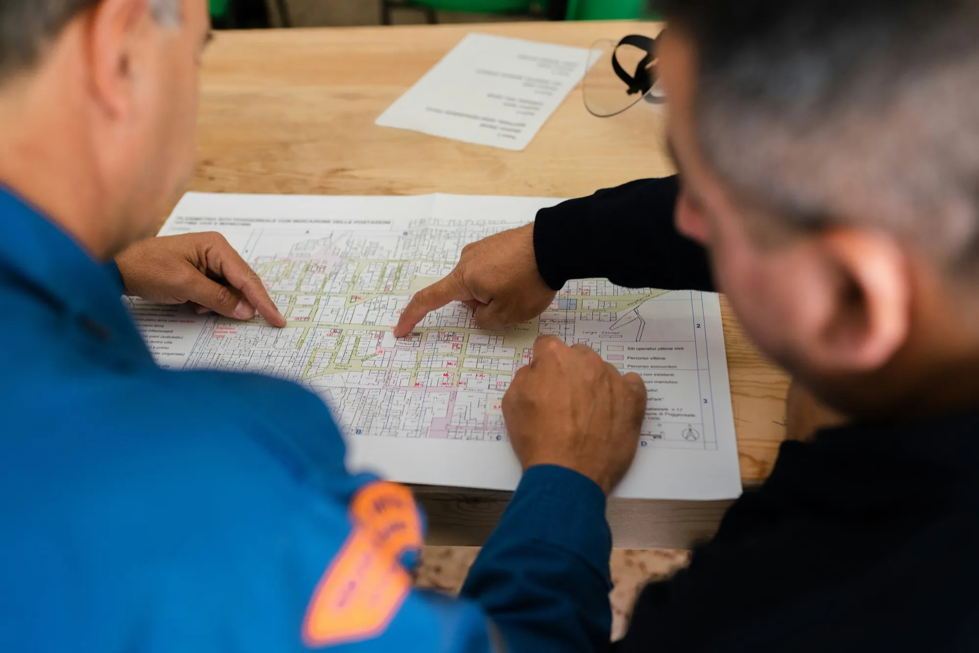 Site engineer in hi-vis reviewing blueprints